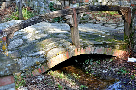 old little bridge over a streamの写真素材