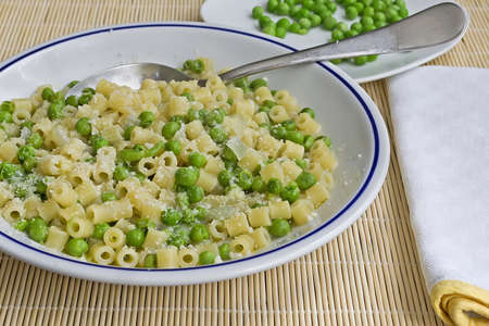 pasta with peas and cheese on a bamboo placematの写真素材