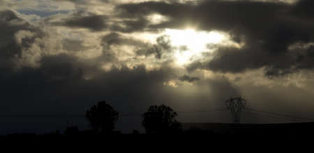 pylon under acloudy sky at sunsetの写真素材