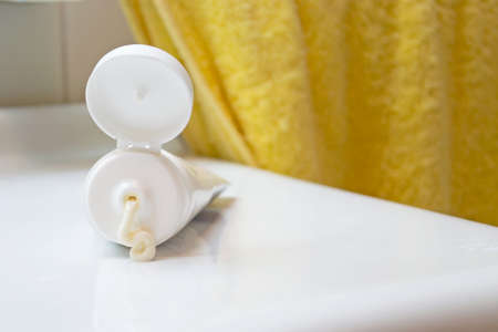 squeezed cream tube on a white sinkの写真素材