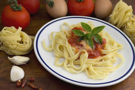 tagliatelle and basil with ingredients all aroundの写真素材