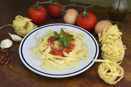 tagliatelle and basil with ingredients all aroundの写真素材