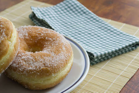two donuts on a ceramic plateの写真素材
