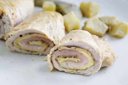 turkey rolls with cheese on a white plateの写真素材