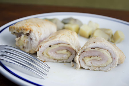 detail of turkey rolls with a fork in the foregroundの写真素材