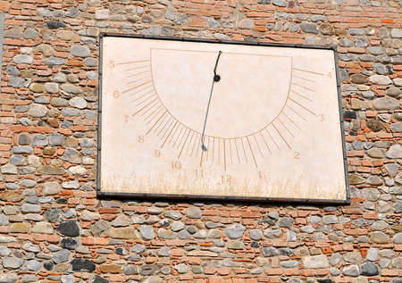 old sundial on a red bricks wallの写真素材