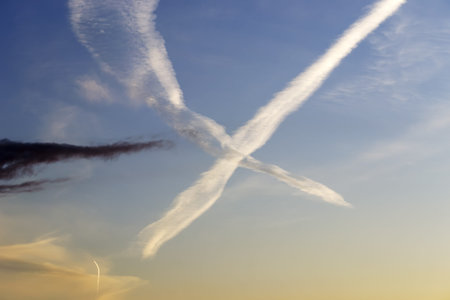 several chemtrails at sunset in the Sardinia sky