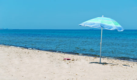 beach umbrella in a desert beachの写真素材