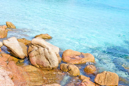 rocks in the clear turquoise water of Costa Smeralda, Sardiniaの写真素材