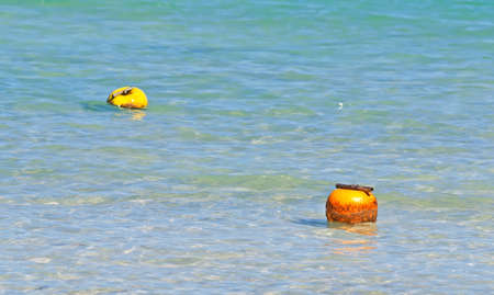 two buoys in turquoise waterの写真素材