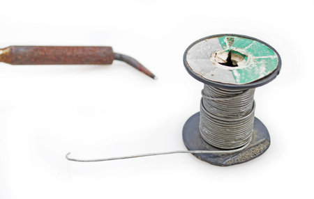 tin spool and soldering iron on whiteの写真素材