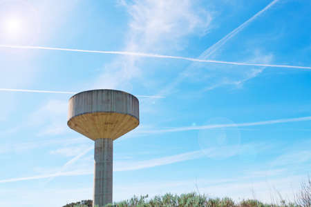 cement reservoir under several chemtrailsの写真素材