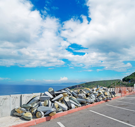 several old streetlamp piled on the street