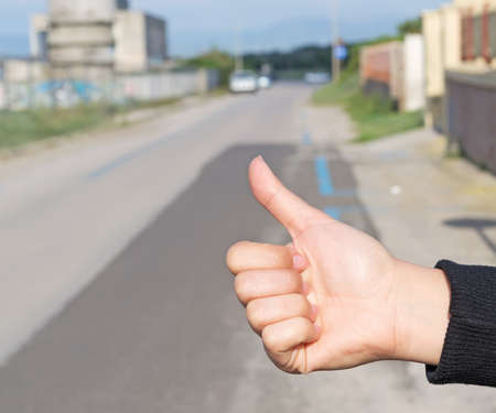 woman hitching a ride in the streetの写真素材