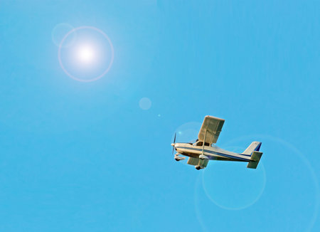 ultra light airplane under a bright sun