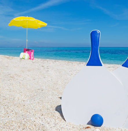 white beach rackets stuck in the sandの写真素材