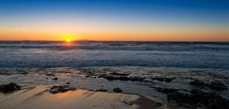 sunset by Castelsardo rocky shoreの写真素材