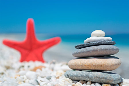stone pile and red seastar on the beachの写真素材