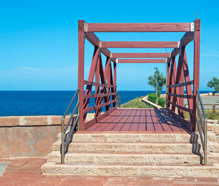 small wooden bridge by the shoreの写真素材