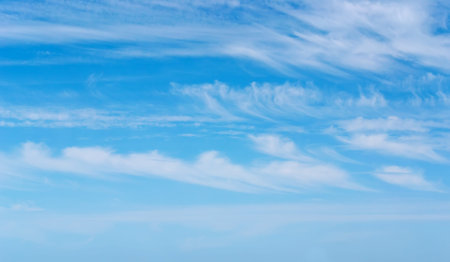 fluffy clouds in the blue skyの写真素材