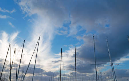 several masts under a dramatic cloudsの写真素材