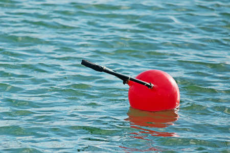 red buoy floating in the waterの写真素材