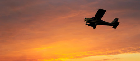 single engine airplane flying at sunset