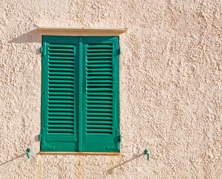 green window in a beige wallの写真素材