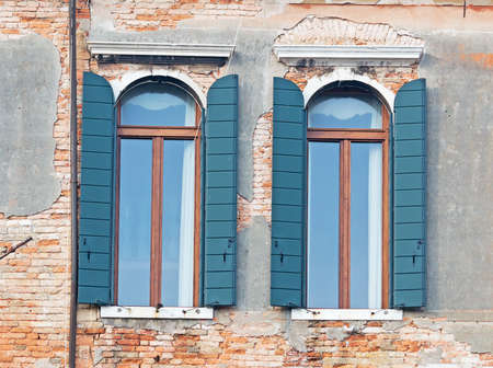 two antique windows in Venice, Italyの写真素材