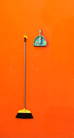 broom and shovel on a wallの写真素材