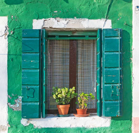 green window in a rustic wallの写真素材