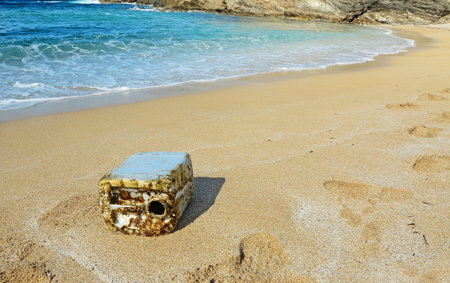 dirty canister by a beautiful shore