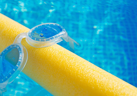 silicon goggles on a yellow pool noodle