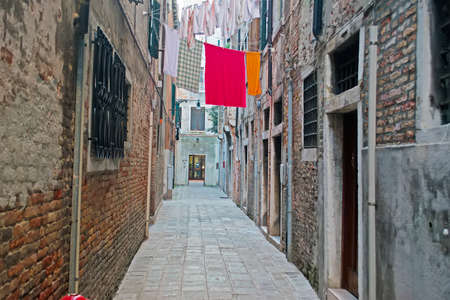 narrow Venetian backstreet with laundry line の写真素材