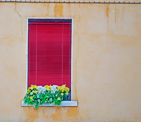 red window in a beige wall