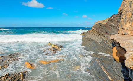 rocky shore with waves in Argentiera