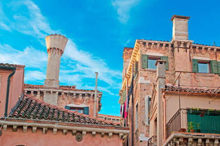 picturesque Venetian roofs under a blue skyの写真素材