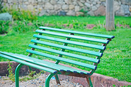 green bench in a parkの写真素材