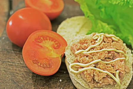 close up of a sandwich with tuna, tomatoes and lettuceの写真素材
