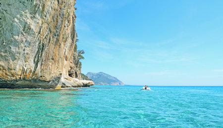sailing by a cliff in Orosei Gulf, Sardiniaの写真素材