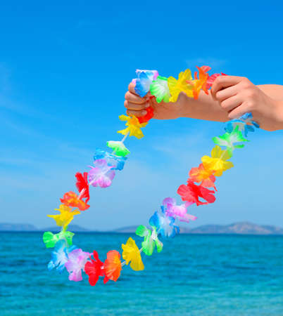 girl holding a hawaiian necklaceの写真素材