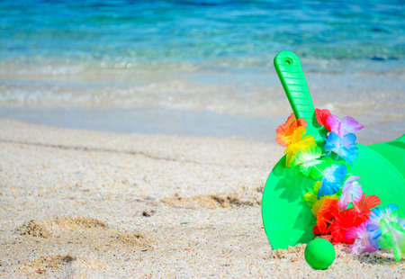 green rackets with hawaiian necklace by the seaの写真素材