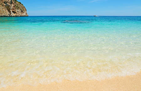 boat in Cala Biriola on a clear day, Sardiniaの写真素材