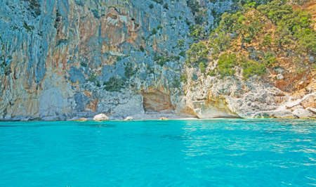 rocky shore in Orosei Gulf seen from the seaの写真素材