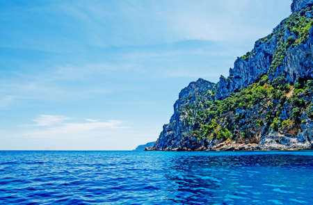 rocky shore in Orosei Gulf in blue toneの写真素材