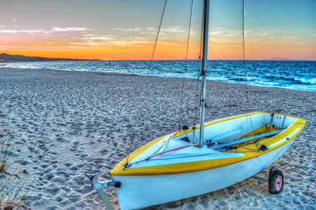 white boat on the sand at duskの写真素材