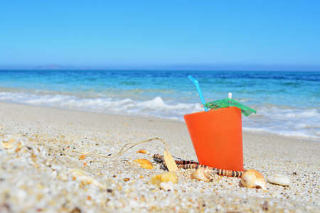 orange drink by the shoreの写真素材