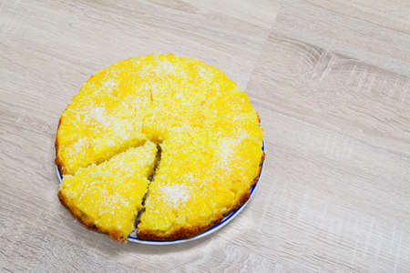 pineapple and coconut cake on a wooden tableの写真素材