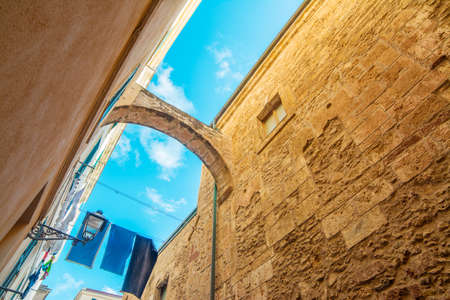 arch in Alghero old town, Italyの写真素材
