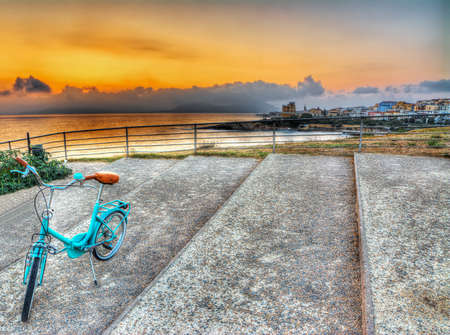 old bicycle at dusk in Alghero, Sardinia. hdrの写真素材